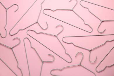 Photo of Many hangers on pink background, flat lay