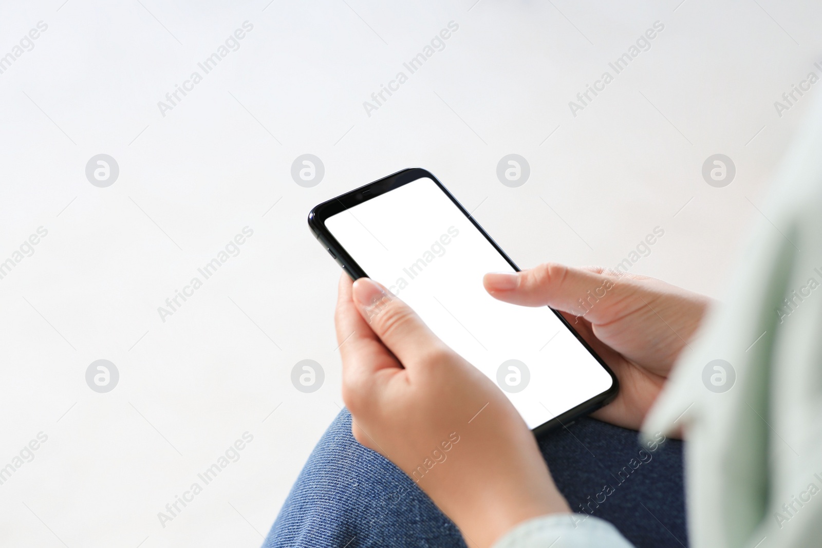 Photo of Closeup view of woman with smartphone indoors. Space for text