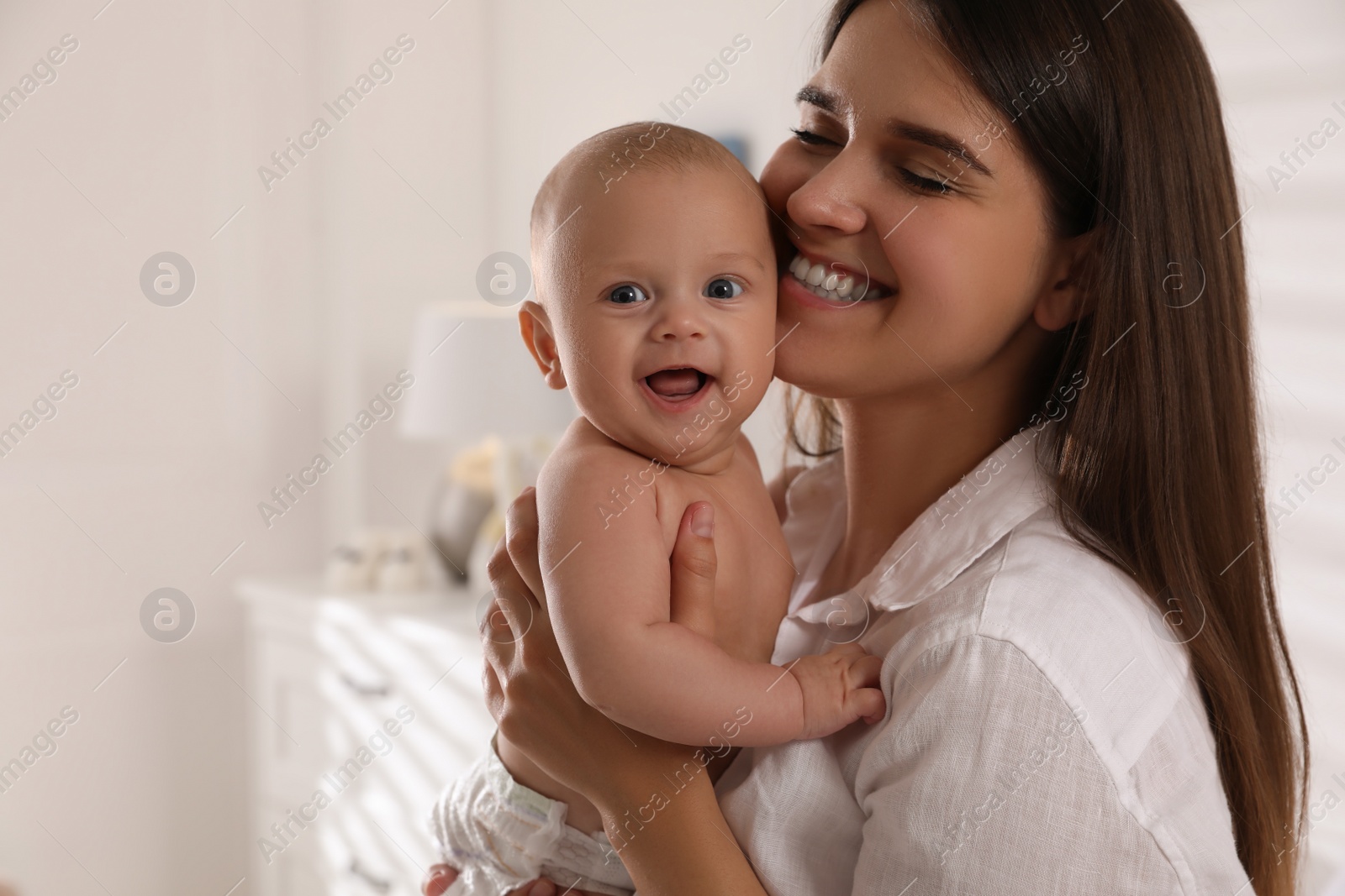 Photo of Happy young mother with her cute baby at home