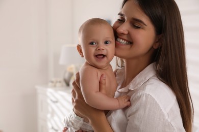 Happy young mother with her cute baby at home