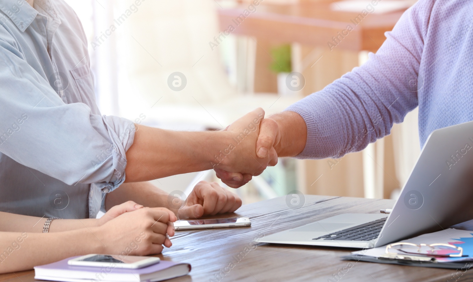 Photo of Mature manager and client shaking hands in office. Consulting service concept