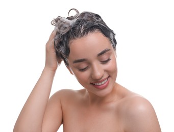 Beautiful happy woman washing hair on white background