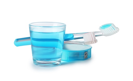 Mouthwash and other items for teeth care on white background