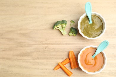 Flat lay composition with healthy baby food and ingredients on wooden table. Space for text