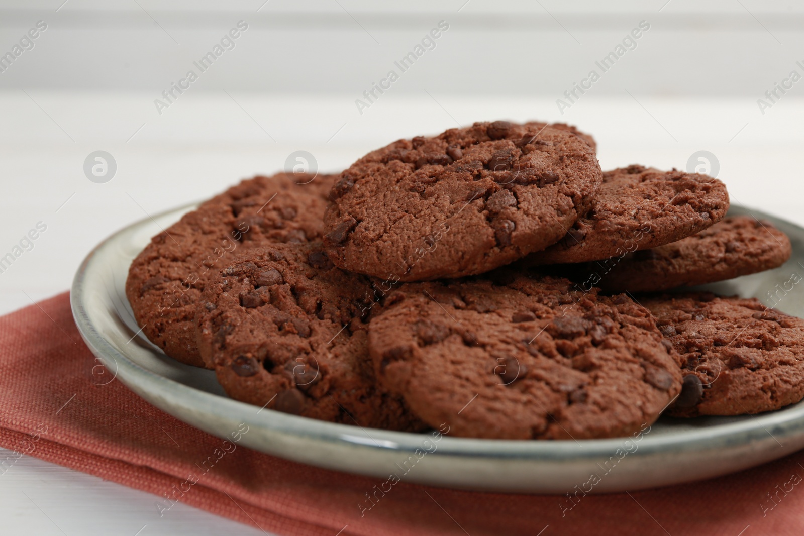 Photo of Delicious chocolate chip cookies on white table, closeup