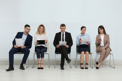 Photo of People waiting for job interview in office hall