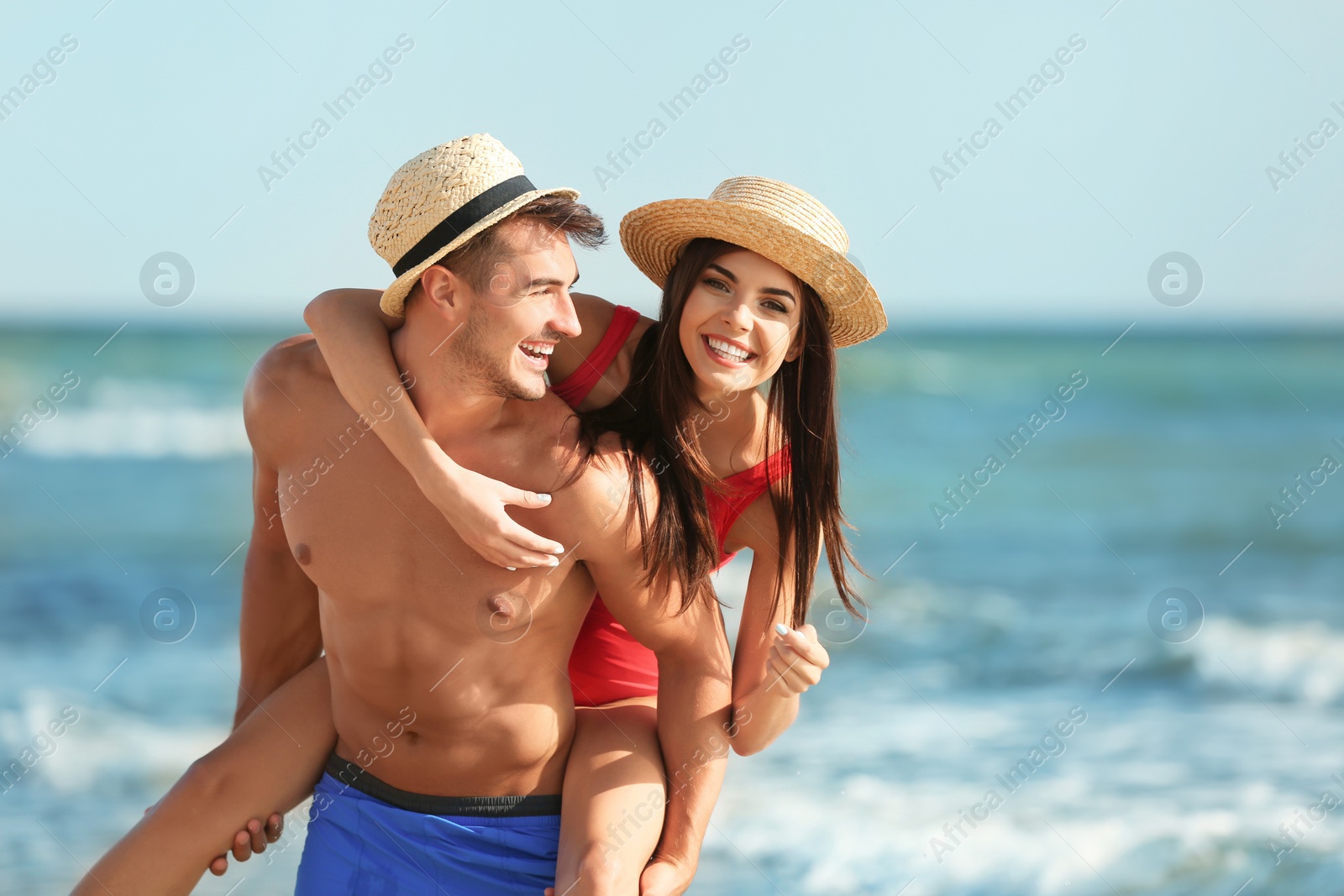 Photo of Happy young couple having fun at beach on sunny day