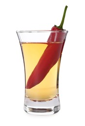 Red hot chili pepper and vodka in shot glass on white background