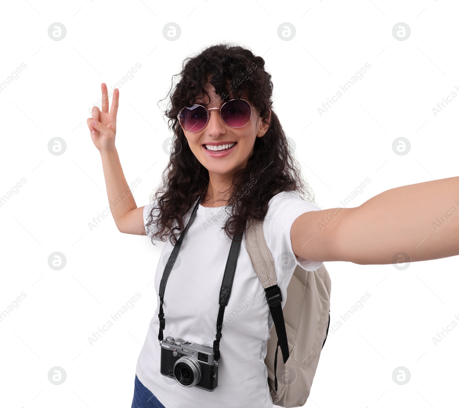 Photo of Beautiful woman in sunglasses with camera taking selfie on white background