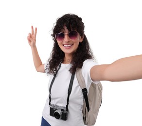 Photo of Beautiful woman in sunglasses with camera taking selfie on white background