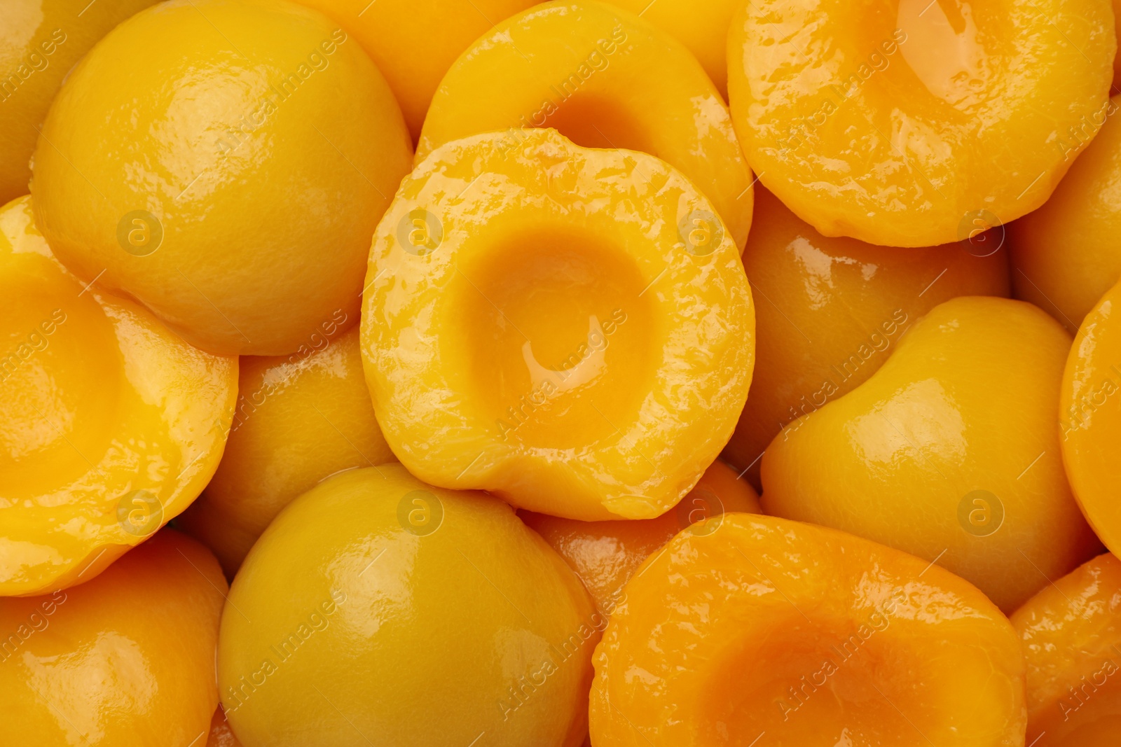 Photo of Halves of canned peaches as background, top view