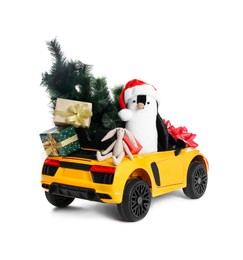 Photo of Child's electric car with toys, gift boxes and Christmas decor on white background