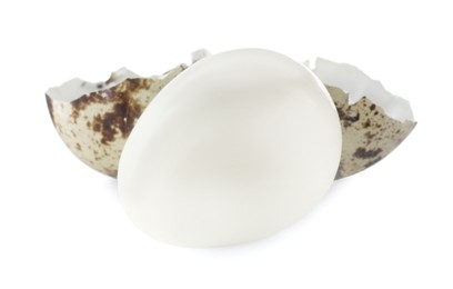 Photo of Peeled boiled quail egg and shell on white background