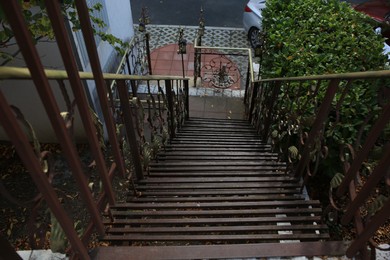 Photo of Beautiful old metal stairs with handrails outdoors, above view