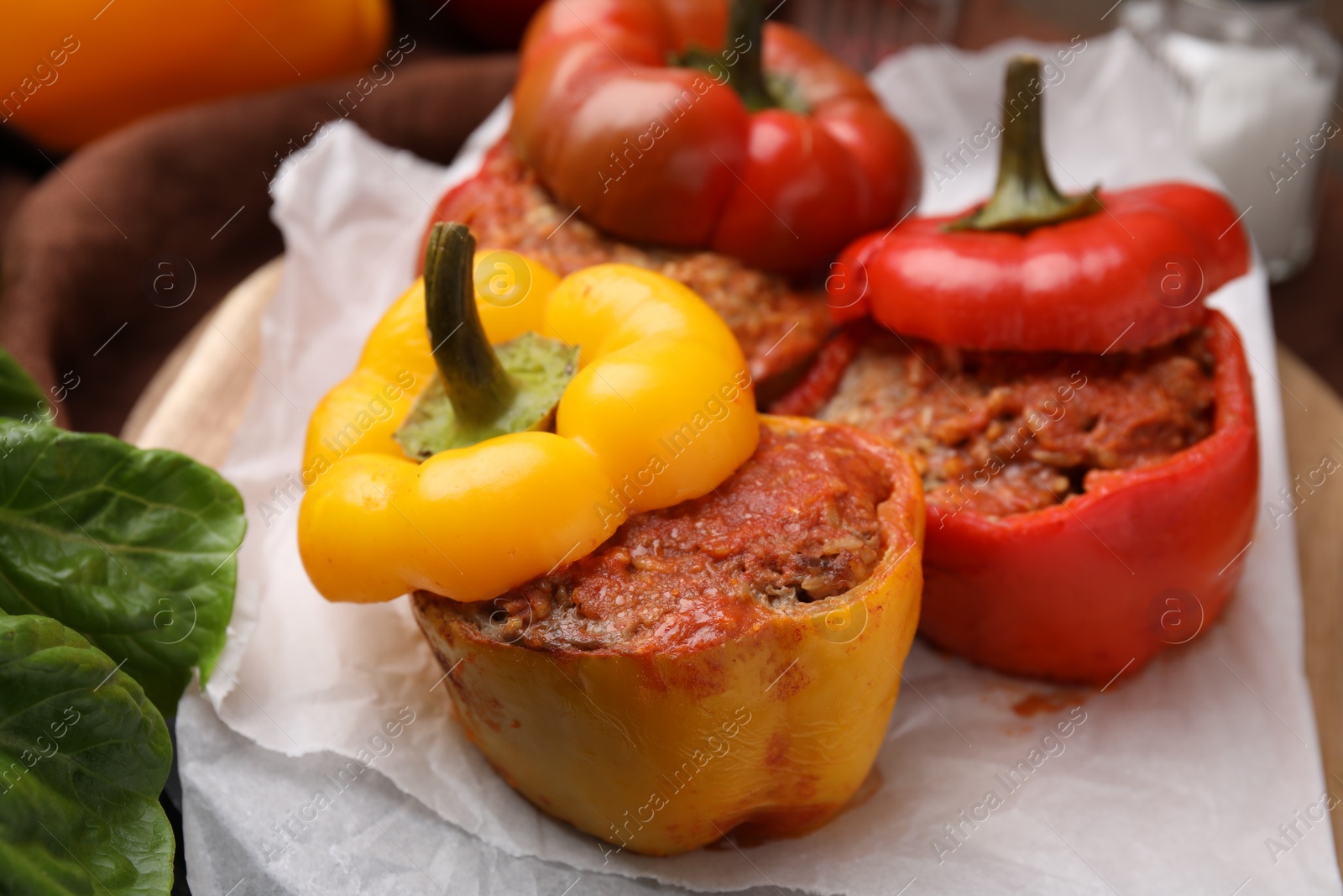 Photo of Delicious stuffed bell peppers served on table, closeup