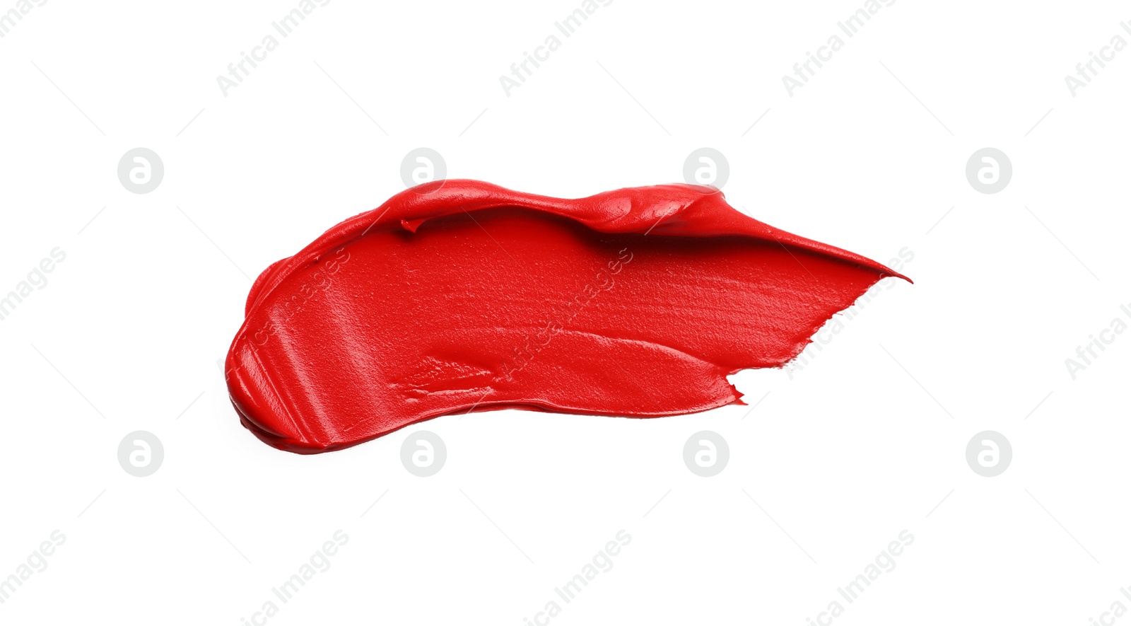 Photo of Red oil paint stroke on white background, top view