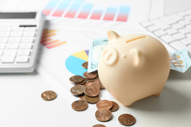 Photo of Piggy bank and money on light table. Space for text