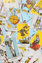 Photo of Many tarot cards as background, top view