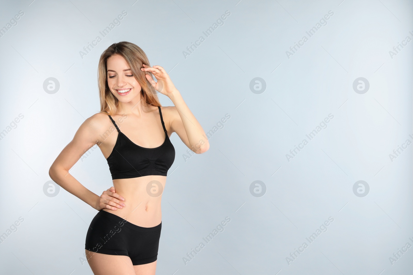 Photo of Young slim woman on light background, space for text. Perfect body