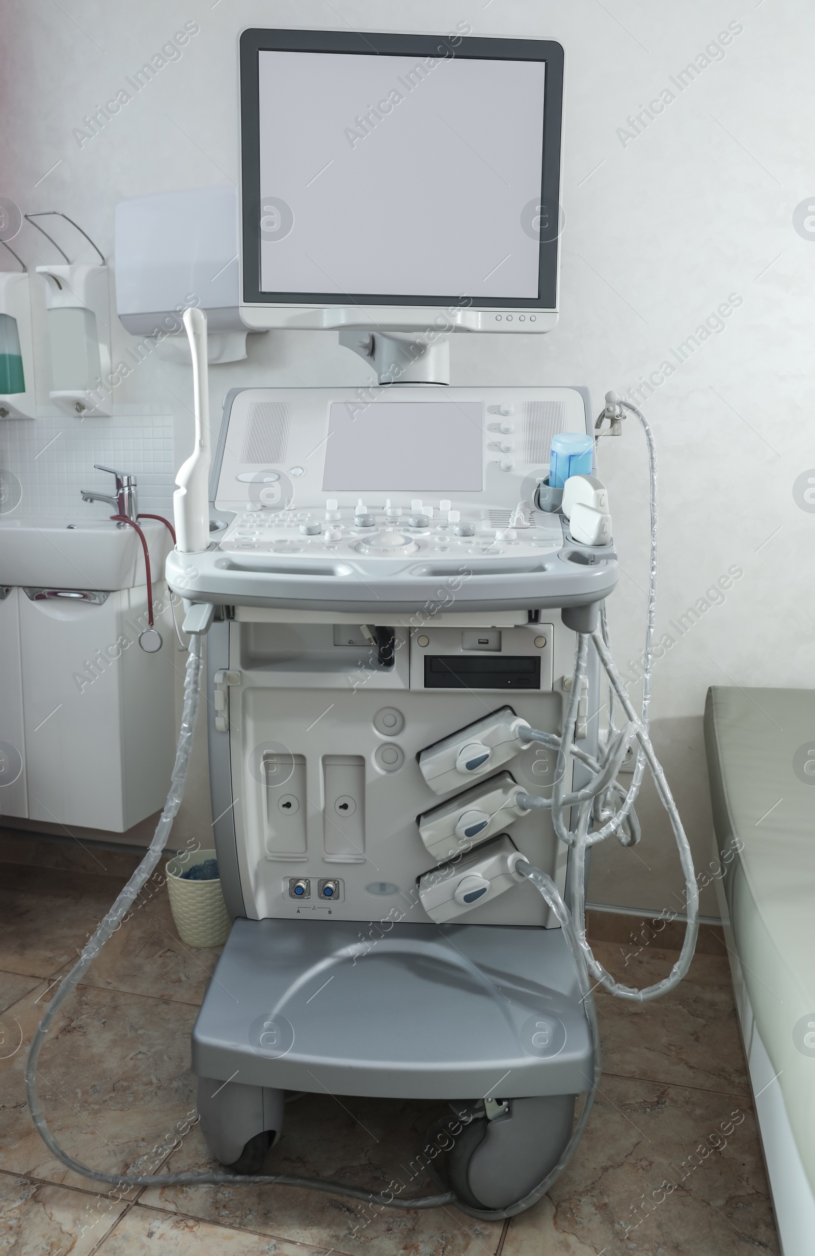 Photo of Modern ultrasound machine in clinic, space for text