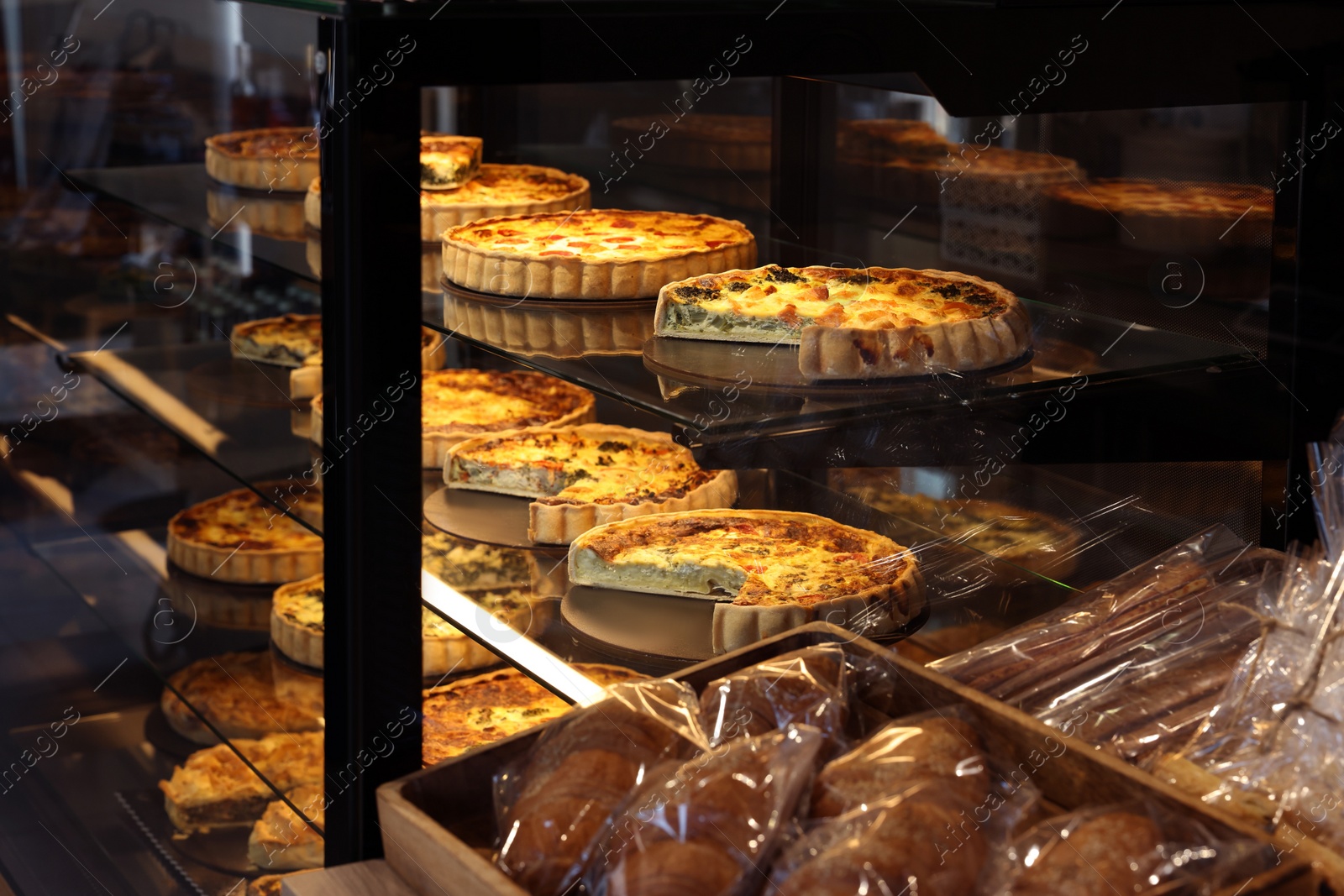 Photo of Counter with different tasty pastries in bakery shop