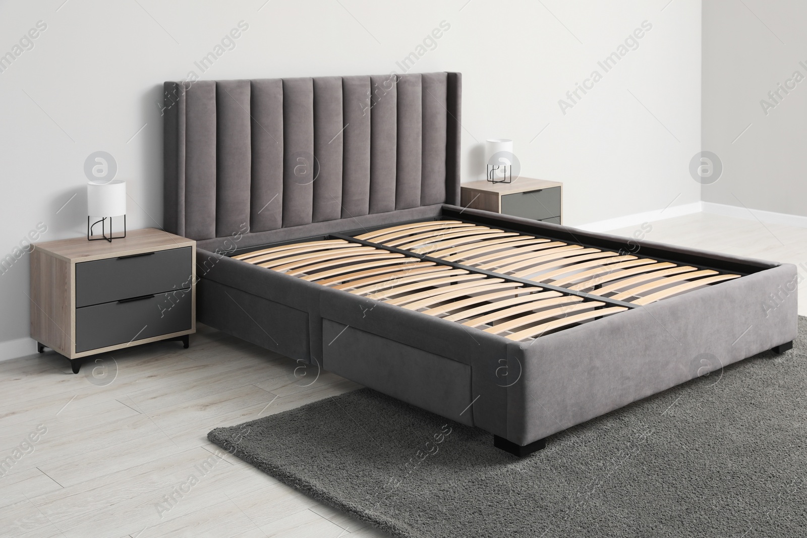 Photo of Comfortable bed with storage space for bedding under slatted base in room