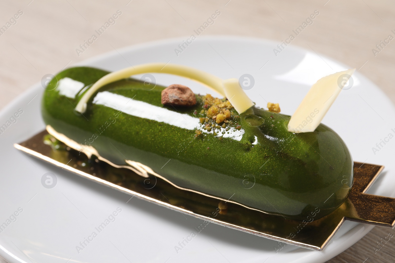 Photo of Delicious dessert decorated with white chocolate on table, closeup