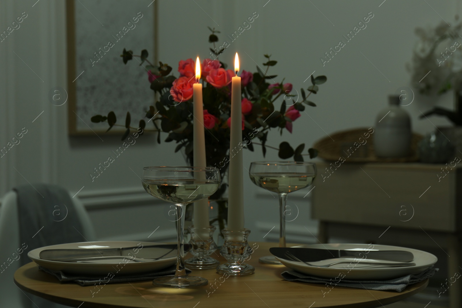 Photo of Romantic table setting with candles and flowers