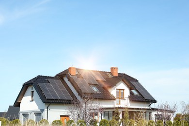 House with installed solar panels on roof, space for text. Alternative energy