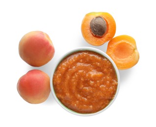 Apricot puree in bowl and fresh fruits on white background, top view