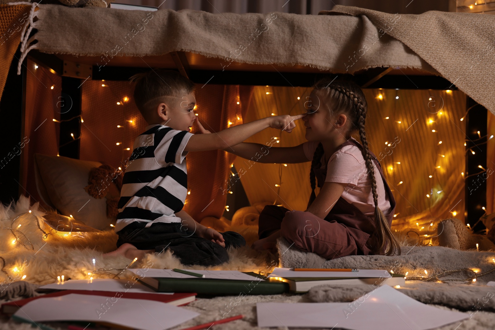 Photo of Children playing in play tent at home