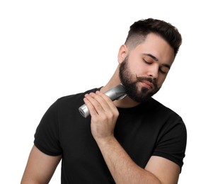 Photo of Handsome young man trimming beard on white background
