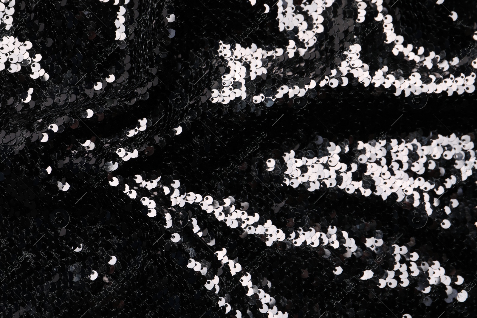Photo of Beautiful dark sequin fabric as background, top view