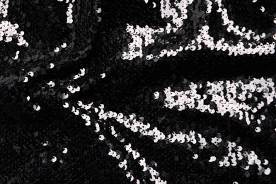 Beautiful dark sequin fabric as background, top view