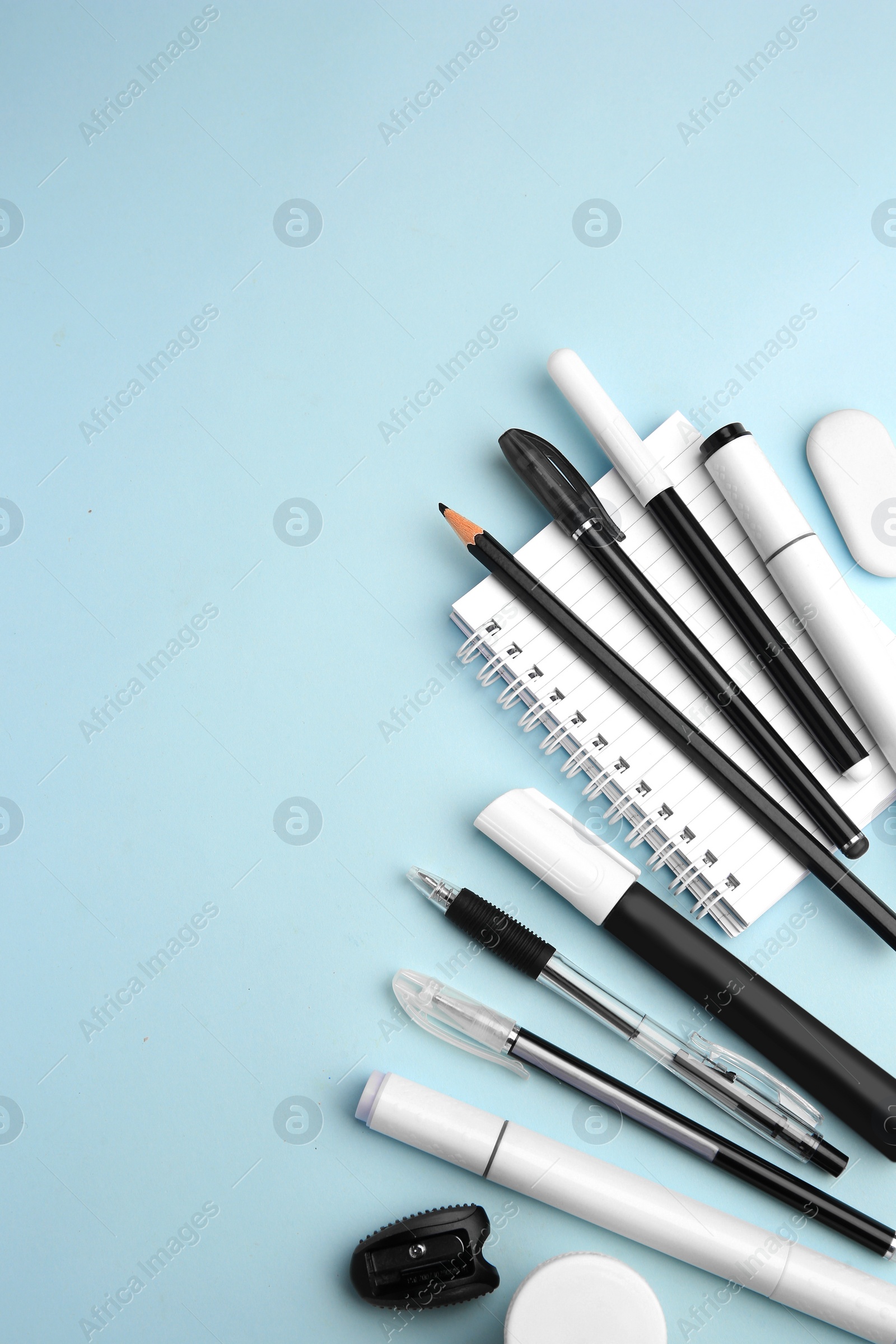 Photo of Flat lay composition with different school stationery on light blue background, space for text. Back to school