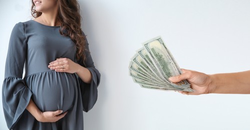 Surrogacy. Intended mother with money and pregnant woman on light background, banner design
