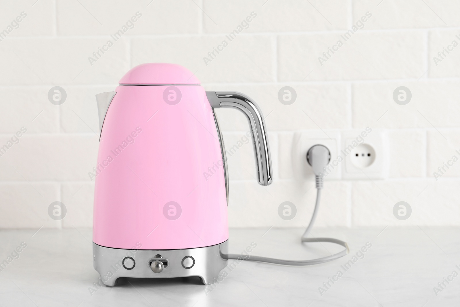 Photo of Modern electric kettle on counter in kitchen