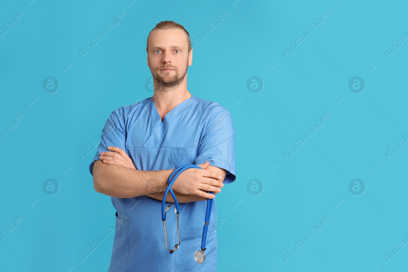 Photo of Portrait of medical assistant with stethoscope on color background. Space for text