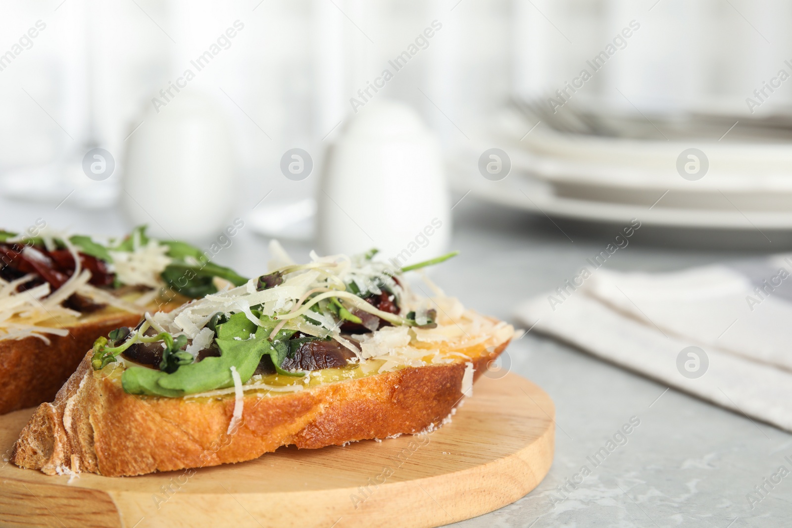 Photo of Delicious bruschettas with beef and cheese on marble table, closeup