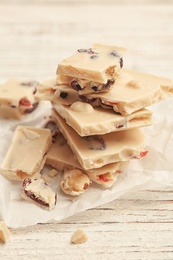 Photo of Yummy chocolate pieces on wooden table