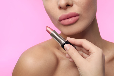 Photo of Woman with matte lipstick on pink background, closeup