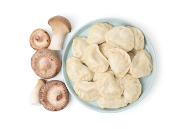 Photo of Plate of delicious dumplings (varenyky) and fresh mushrooms isolated on white, top view