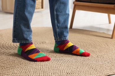 Man in stylish colorful socks and jeans indoors, closeup