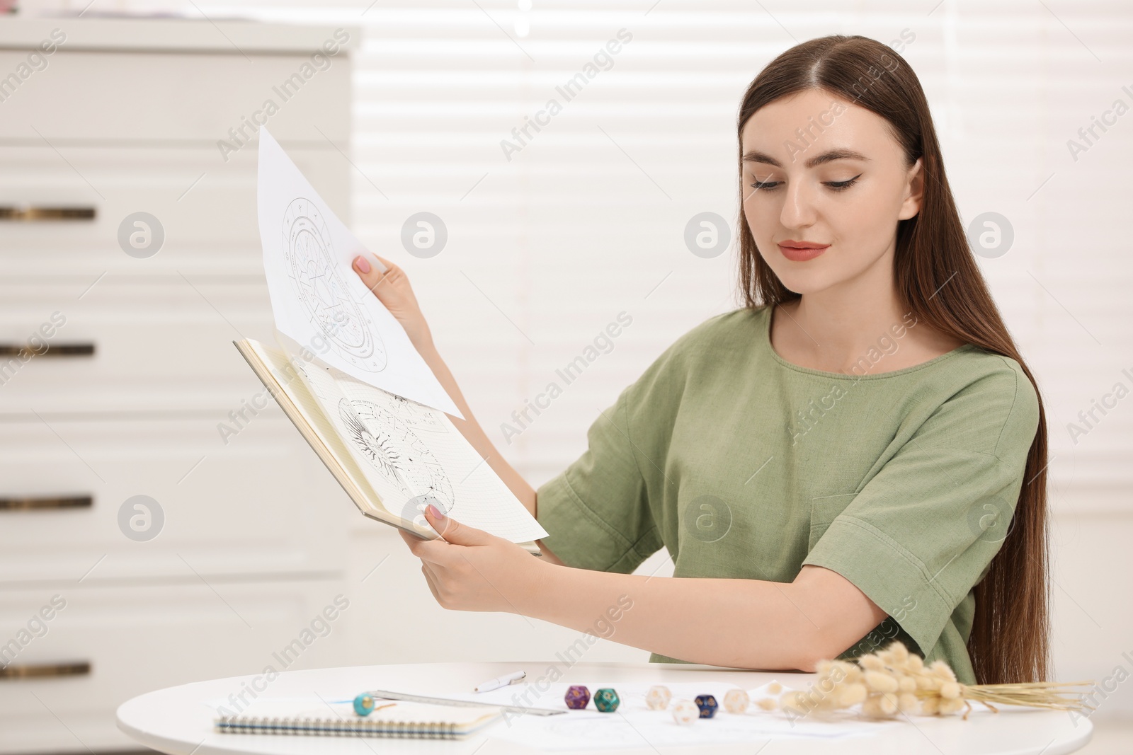 Photo of Astrologer making forecast of fate at table indoors. Fortune telling
