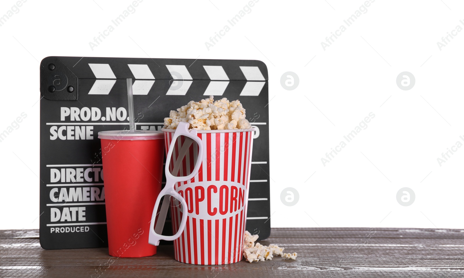 Photo of Delicious popcorn, drink, 3D glasses and clapperboard on wooden table against white background