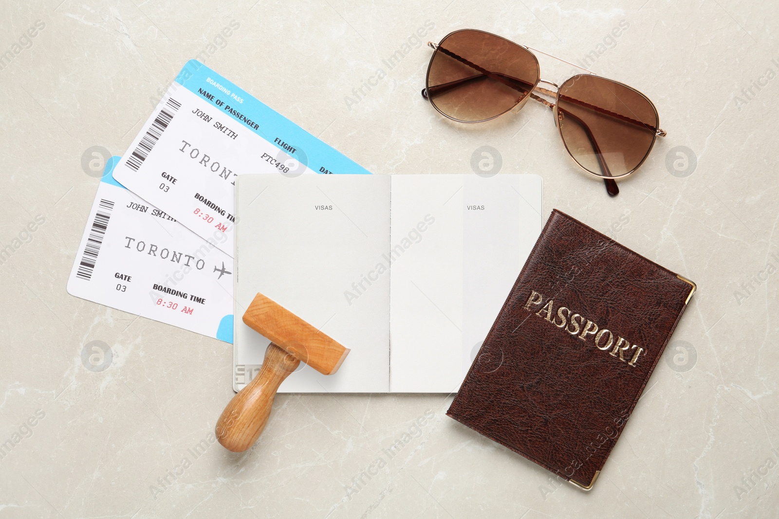 Photo of Flat lay composition with passports, stamp and flight tickets on light table