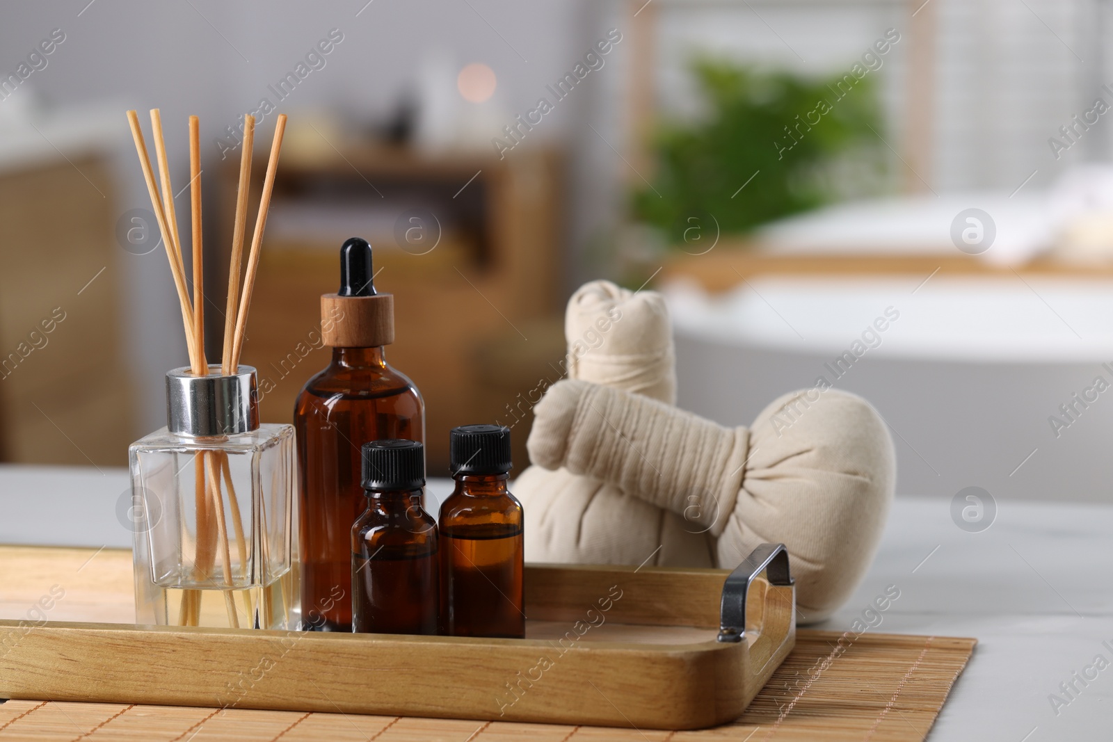 Photo of Spa products on white table in bathroom, closeup