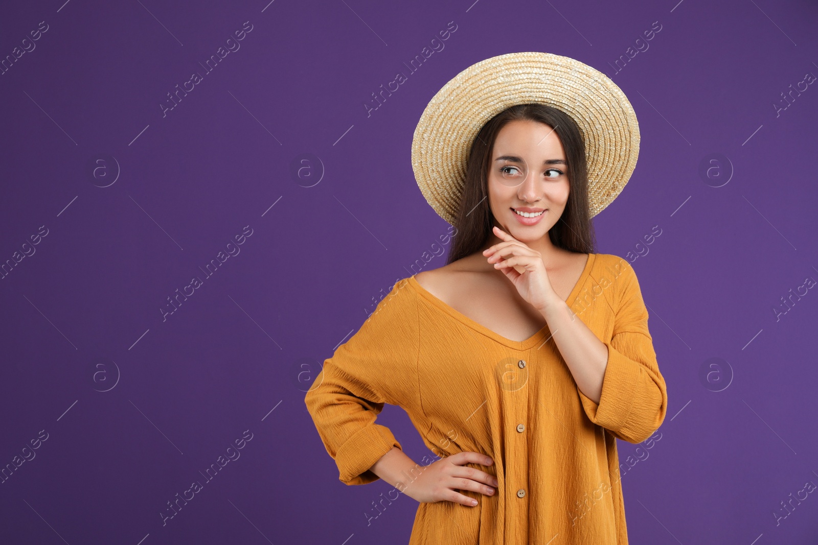 Photo of Young woman wearing stylish dress on purple background. Space for text