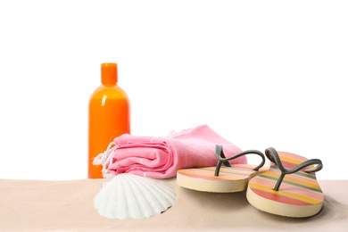 Photo of Different stylish beach accessories on sand against white background