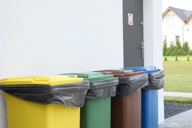 Photo of Recycling bins for different garbage outdoors. Waste sorting